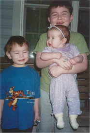 Matt holds Emma next to Luke